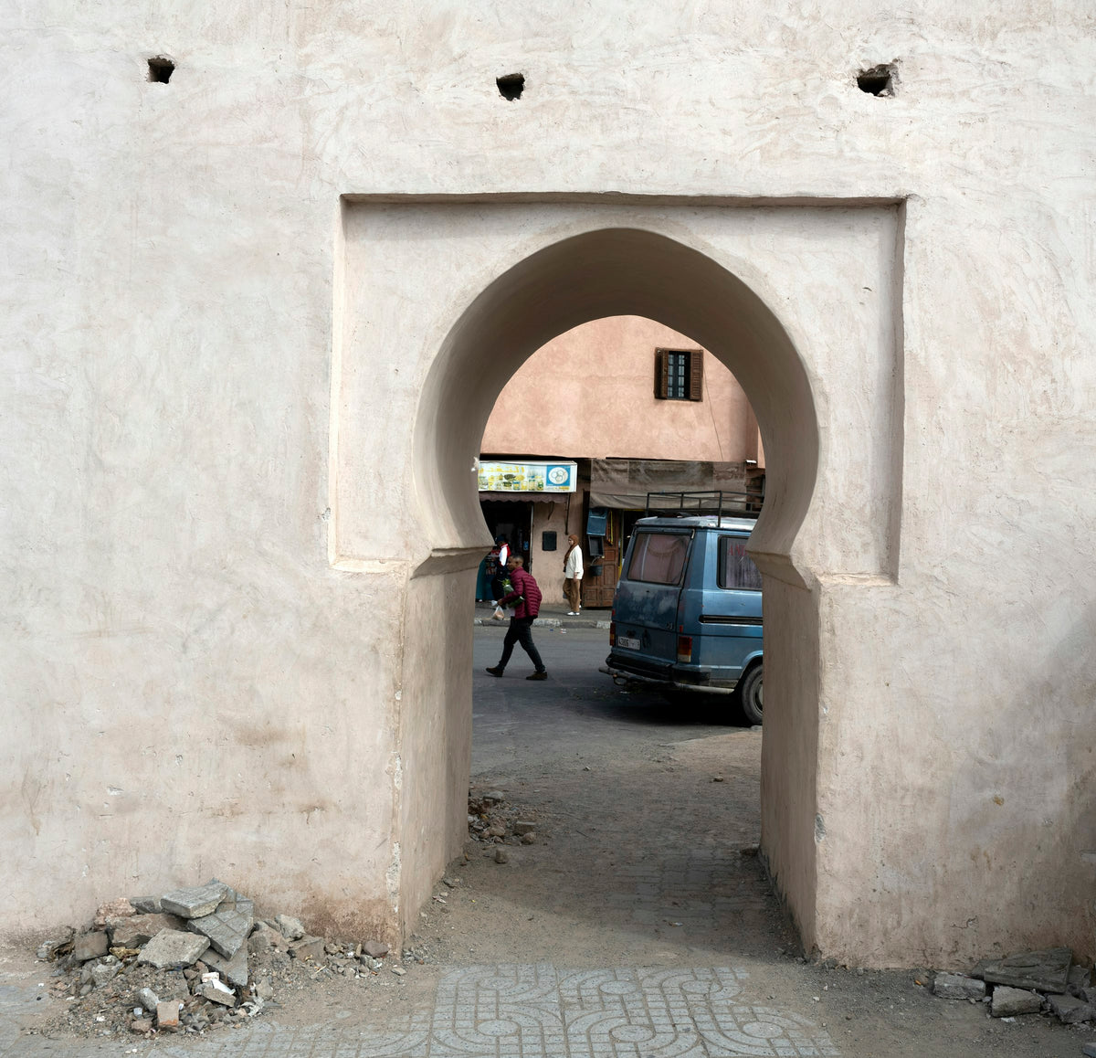 Arched gateway opening onto a medina street