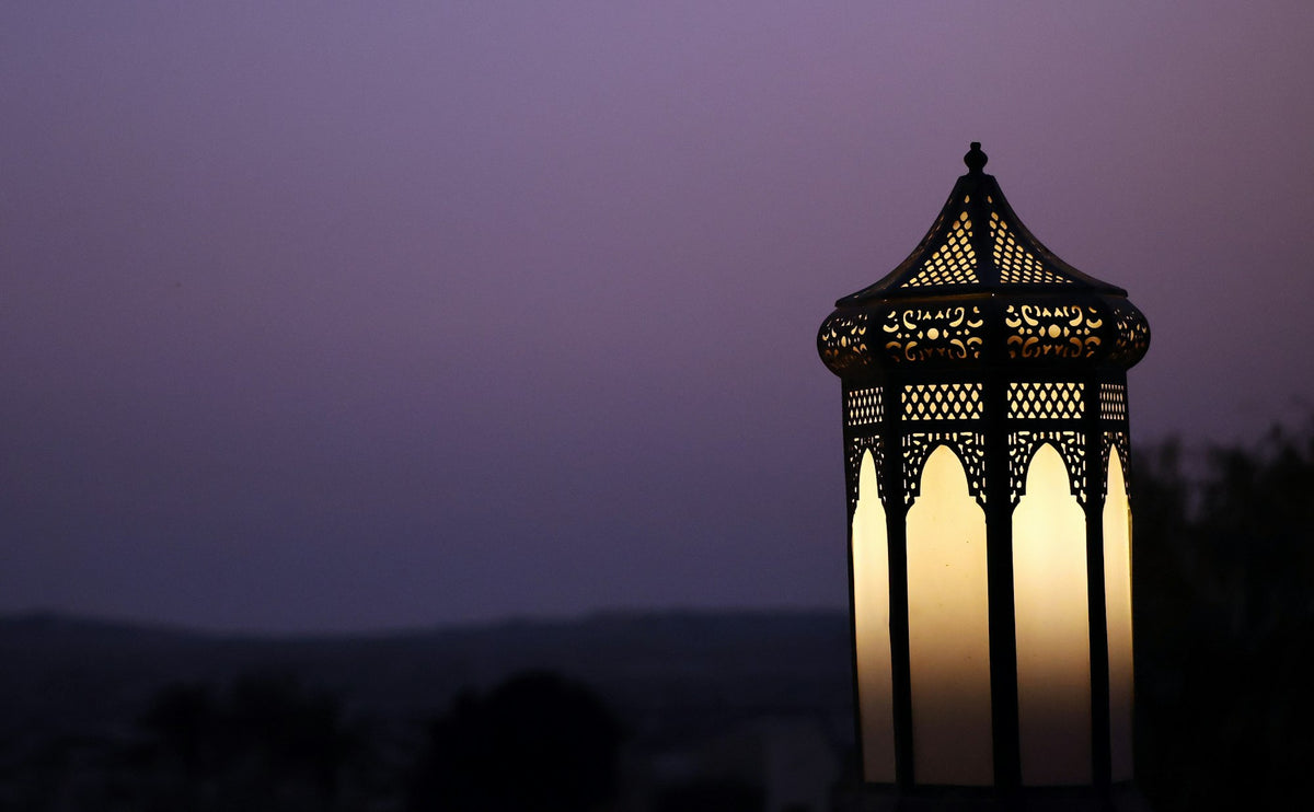 Ornate lantern glowing against a twilight sky